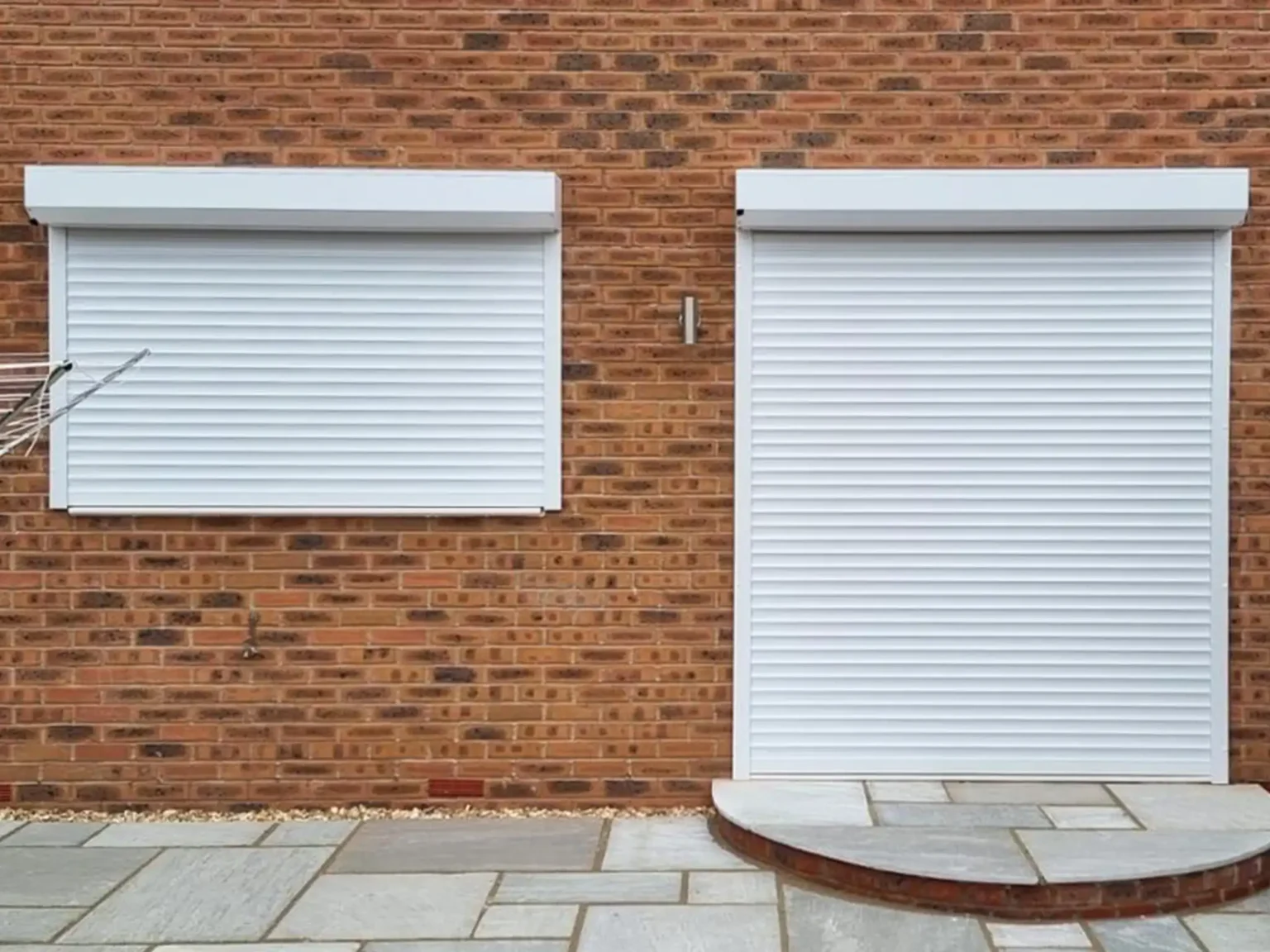 Protecting vulnerable windows and patio doors at the back of a domestic property with Callisto aluminium continental roller shutters.