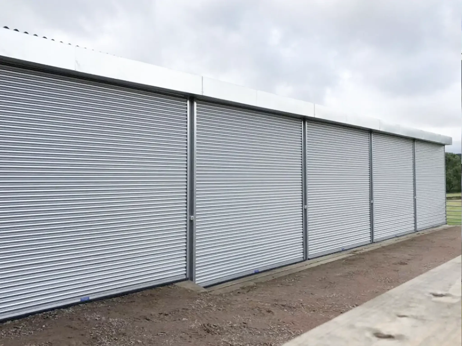 A run of Titan Roller Shutters in galvanised finish with tubular motor powered operation