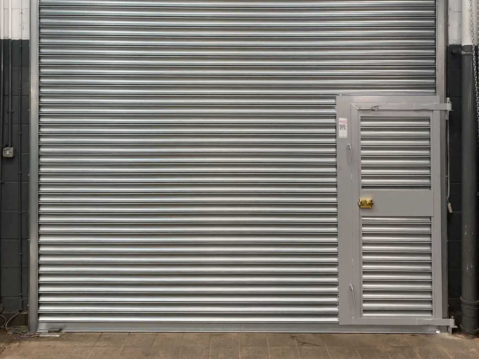 Titan roller shutter incorporating a wicket door for pedestrian access