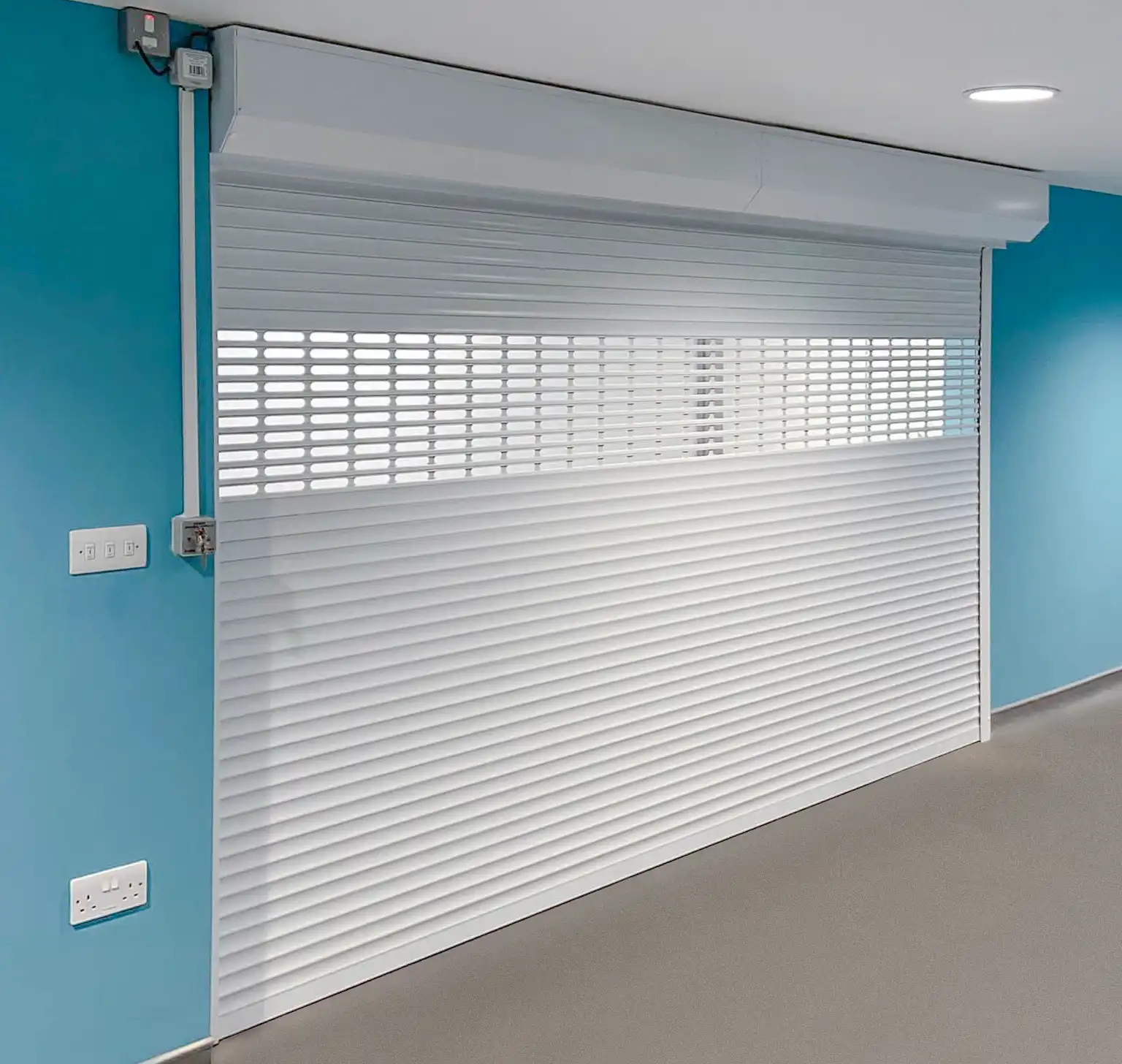 Callisto aluminium continental shutter fitted at a health centre with punched vision